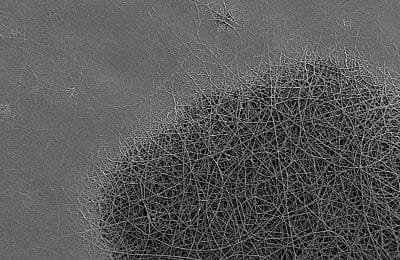 Optically-programmed 'smart label' based on nano-textured non-wovens fibers